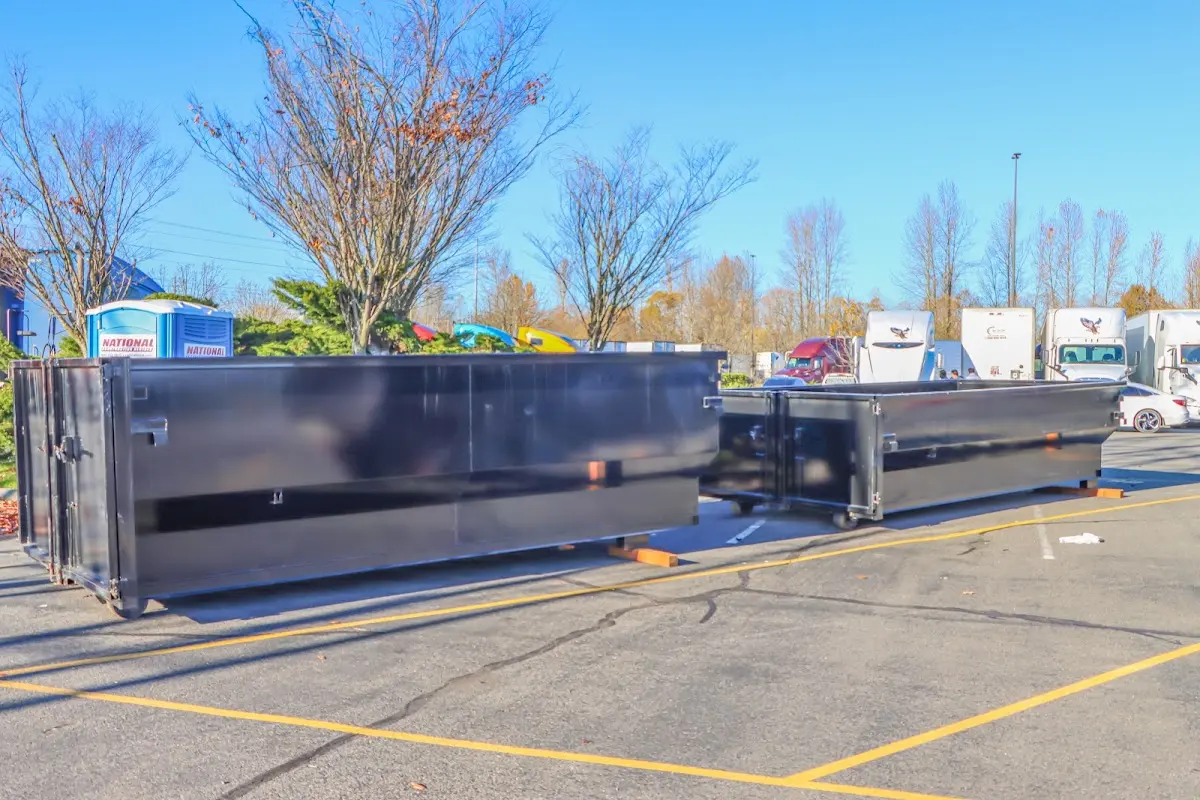 Professional dumpster rental service with roll-off container on residential driveway in Livingston